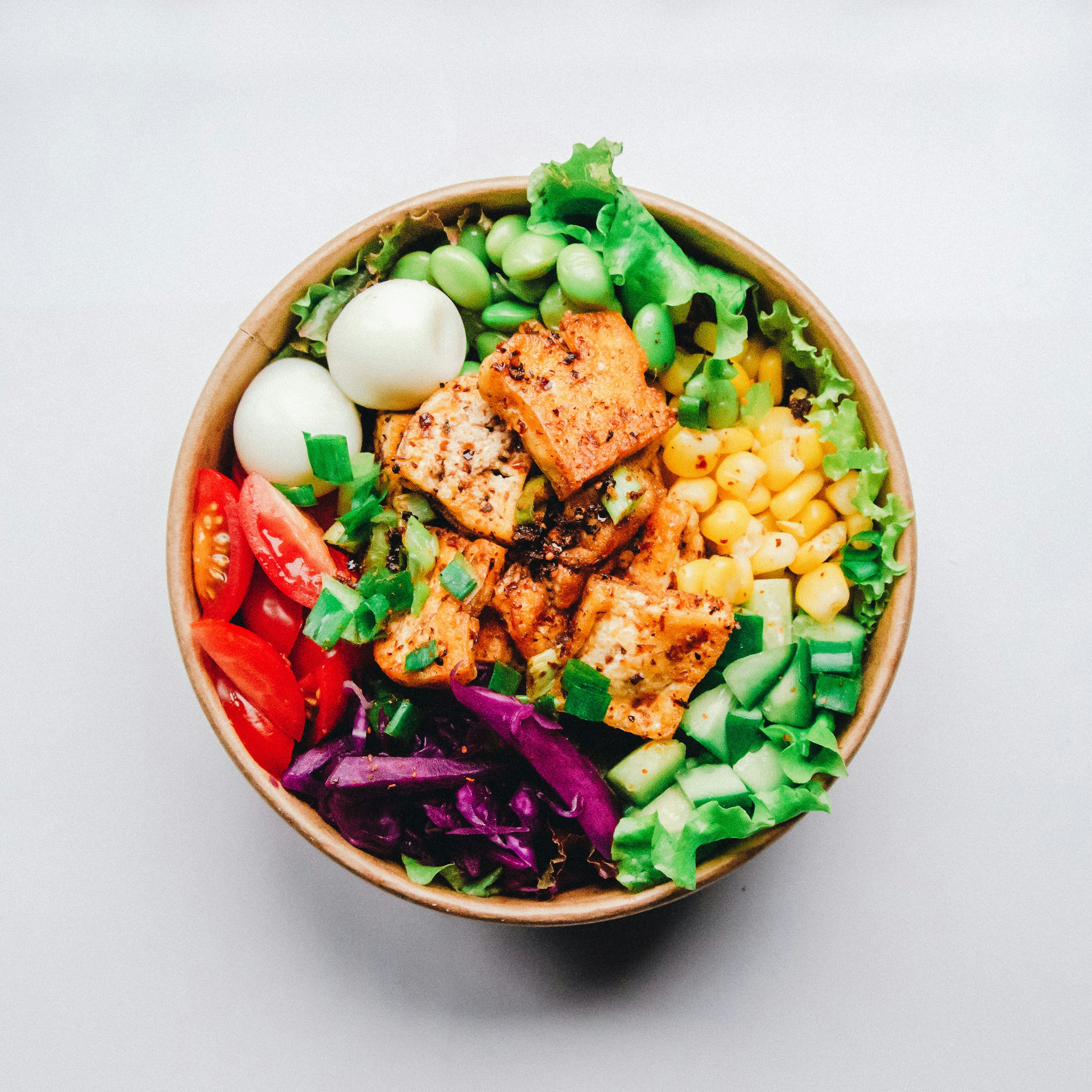 Fresh bowl with rice, chicken, lime, and slaw